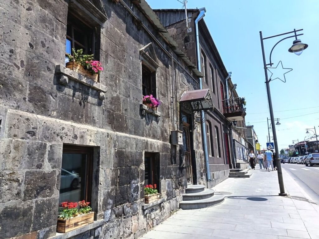 Low-rise buildings in Gyumri made from traditional black tuff. JAMnews photo.