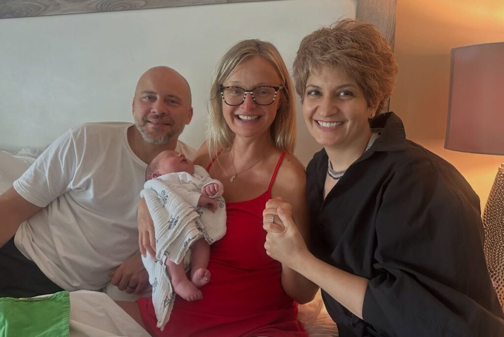 Yvetta with the parents of a baby born with her support